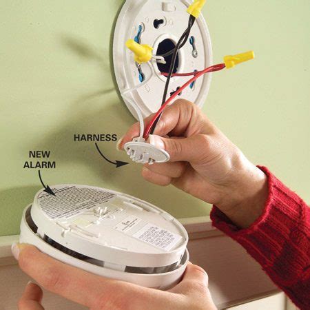 Installing battery operated smoke alarm over electrical junction 